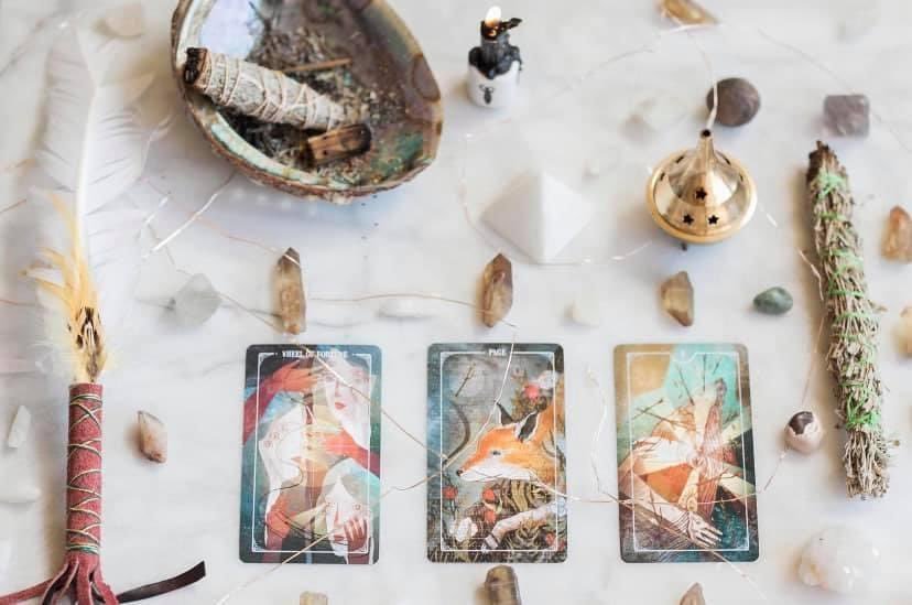Divination flat lay with oracle cards, incense and crystals