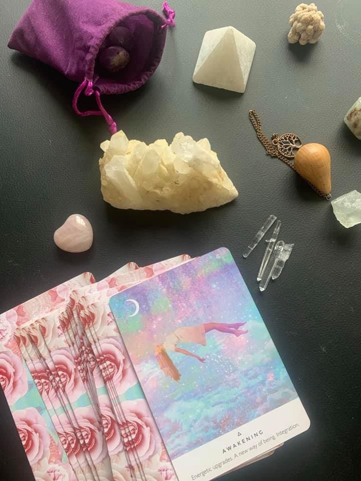 Divination flat lay with oracle cards and crystals